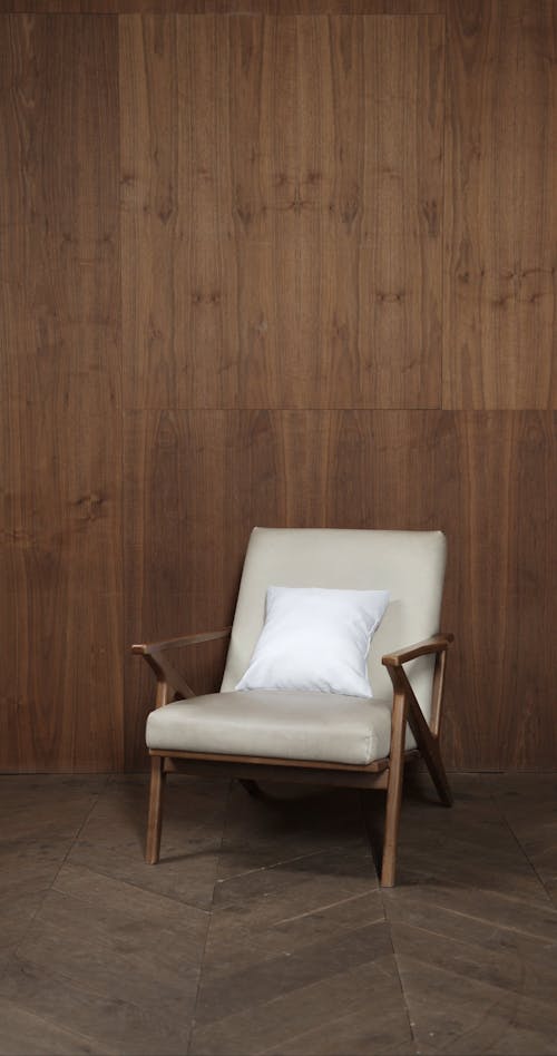 White Throw Pillow on a Wooden Armchair