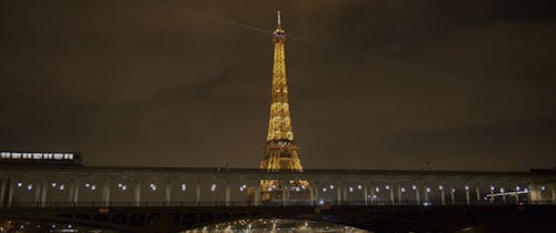 Train Passing by Eiffel Tower at Night