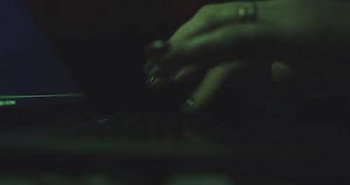 Woman Typing In Low Light Room