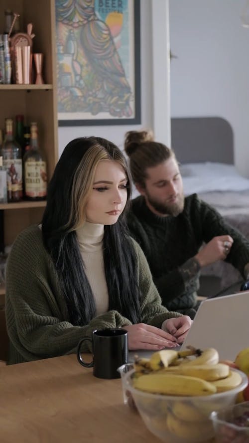 A Couple Using Digital Devices at Home