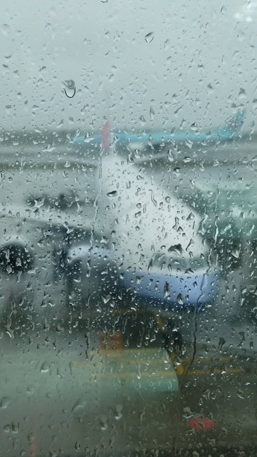 Plane Seen From Airport Window Under Rain