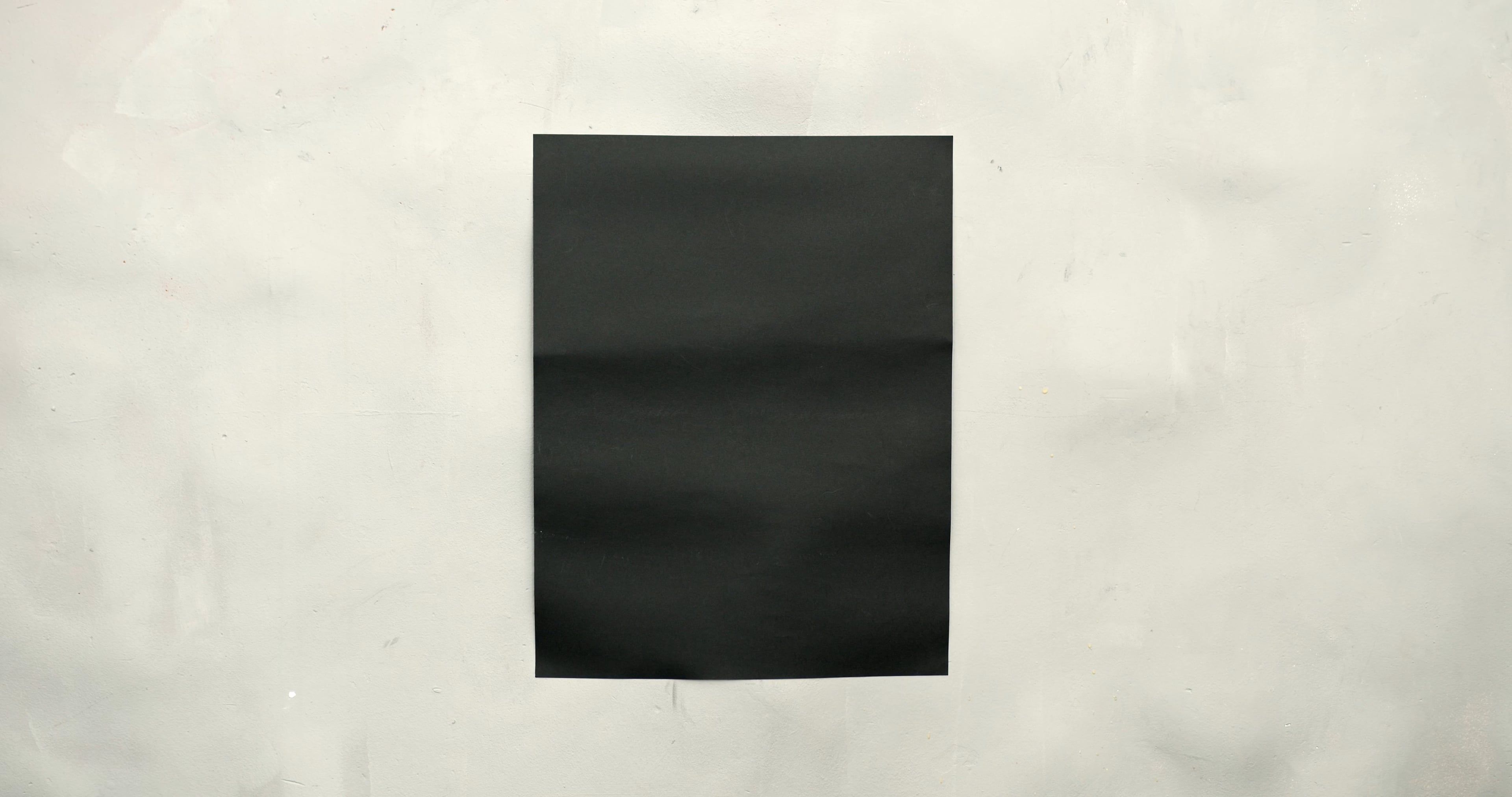 Close Up Shot of a Black Paper in White Background · Free Stock Video