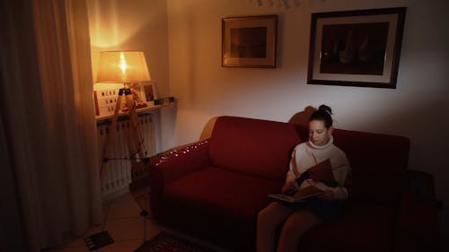 A Girl Flipping Pages of a Book