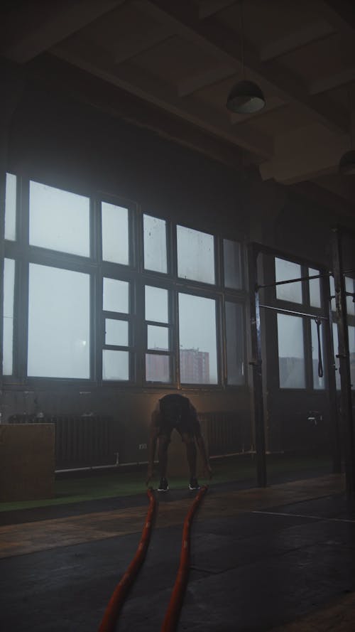 A Man Exercising Using Battle Ropes