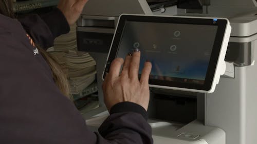 Woman Operating Photocopier