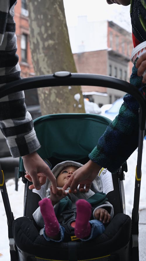 Mom and Dad Holding Hands with Baby in Stroller