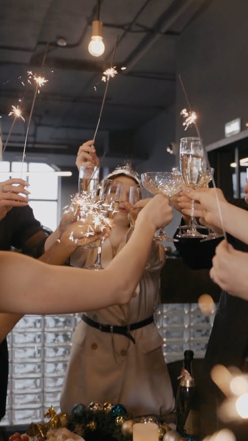 People with Sparklers Clinking Glasses