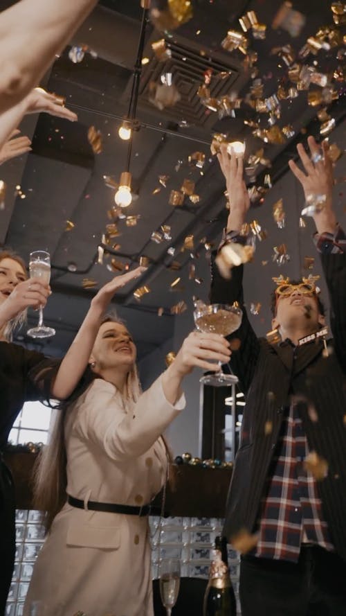 People Raising Glass on a Falling Confetti