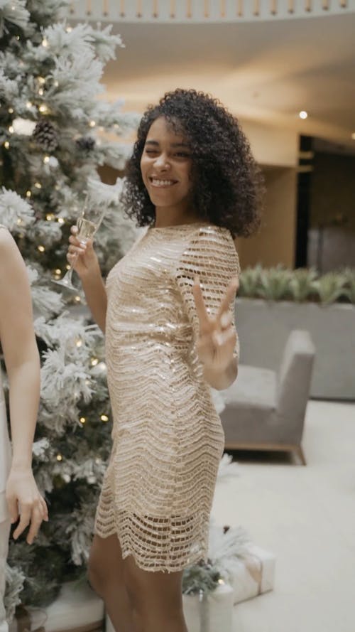 Woman Dancing while Holding a Glass of Champagne