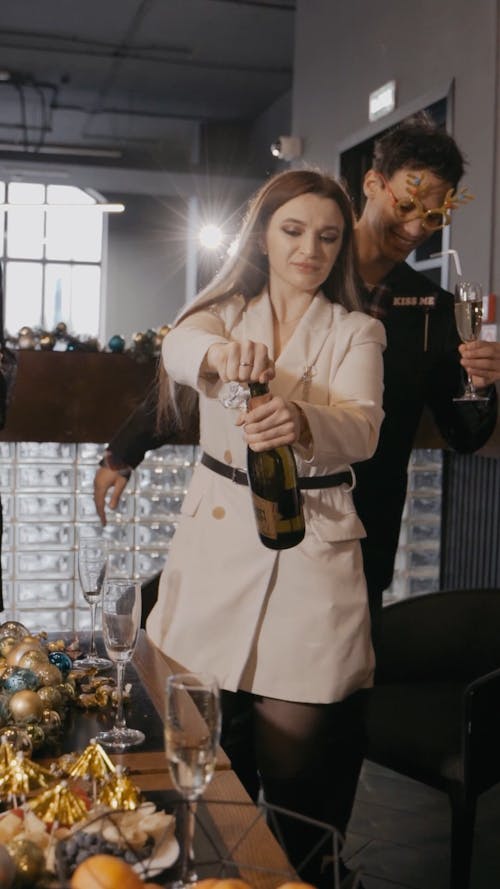 Woman Opening a Bottle of Champagne