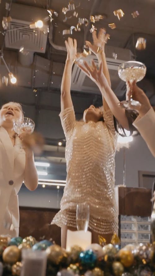 Woman Throwing a Confetti in a Holiday Celebration