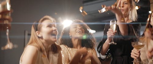 Women Throwing Confetti at a Party