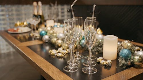 Bottles and Glasses on the Table with Decorations