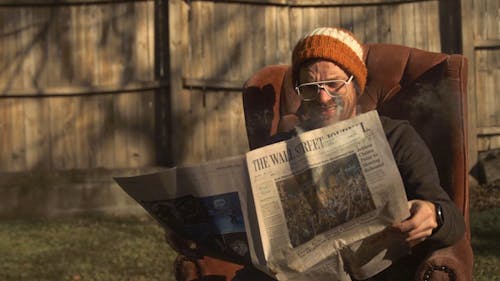 Man Reading a Burning Newspaper