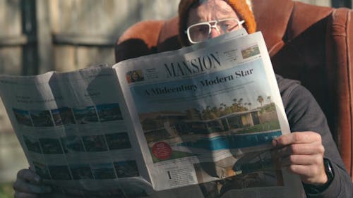 Man Reading a Burning Newspaper