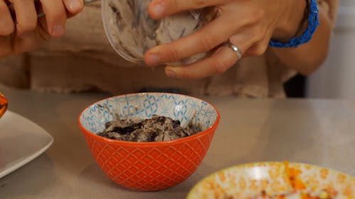 Close Up Shot of a Person Putting Ice Cream in the Cup