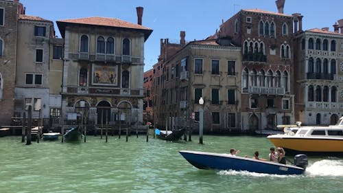 Family Traveling In Waterway Of Venice