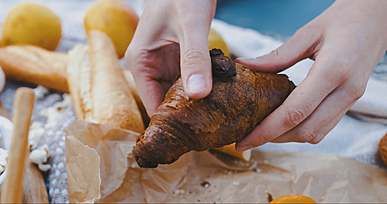a person tearing a bread