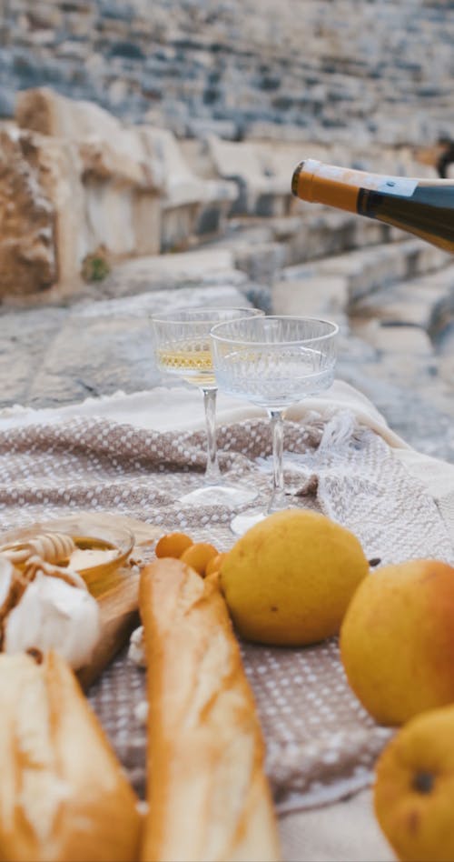 Pouring Glass of Champagne at Picnic 
