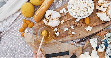 a person using honey dipper