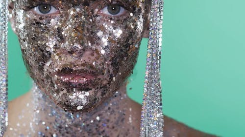 Person Full of Glitters in the Face and Body is Dancing