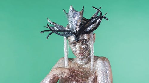 A Woman Dancing With Glitters on Her Face