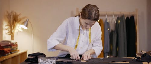 A Woman Putting Marks on a Fabric