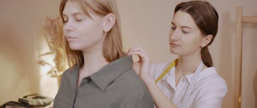 Tailor Measuring Woman's Shirt