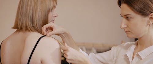 Tailor Measuring Woman's Arm