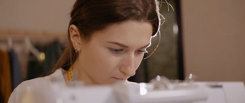 A Woman Using a Sewing Machine