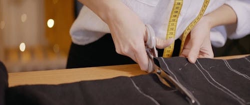 Tailor Cutting Black Fabric