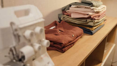 Close Up View of Garments Arranged in a Wooden Rack