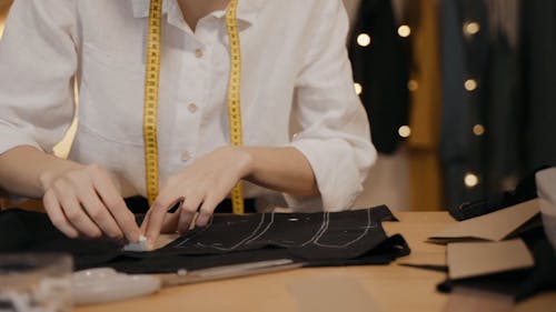 A Female Fashion Designer Marking Garment
