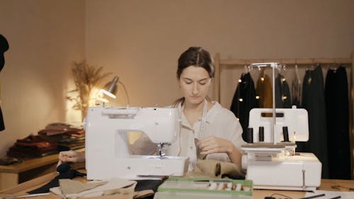 A Woman Sewing a Cloth on the Sewing Machine