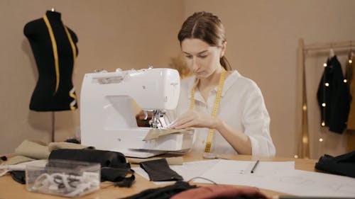 A Woman Sewing on a Sewing Machine