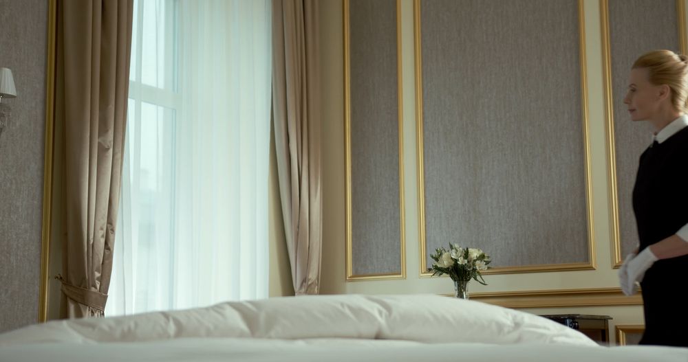 Hotel housekeeper preparing a guest room