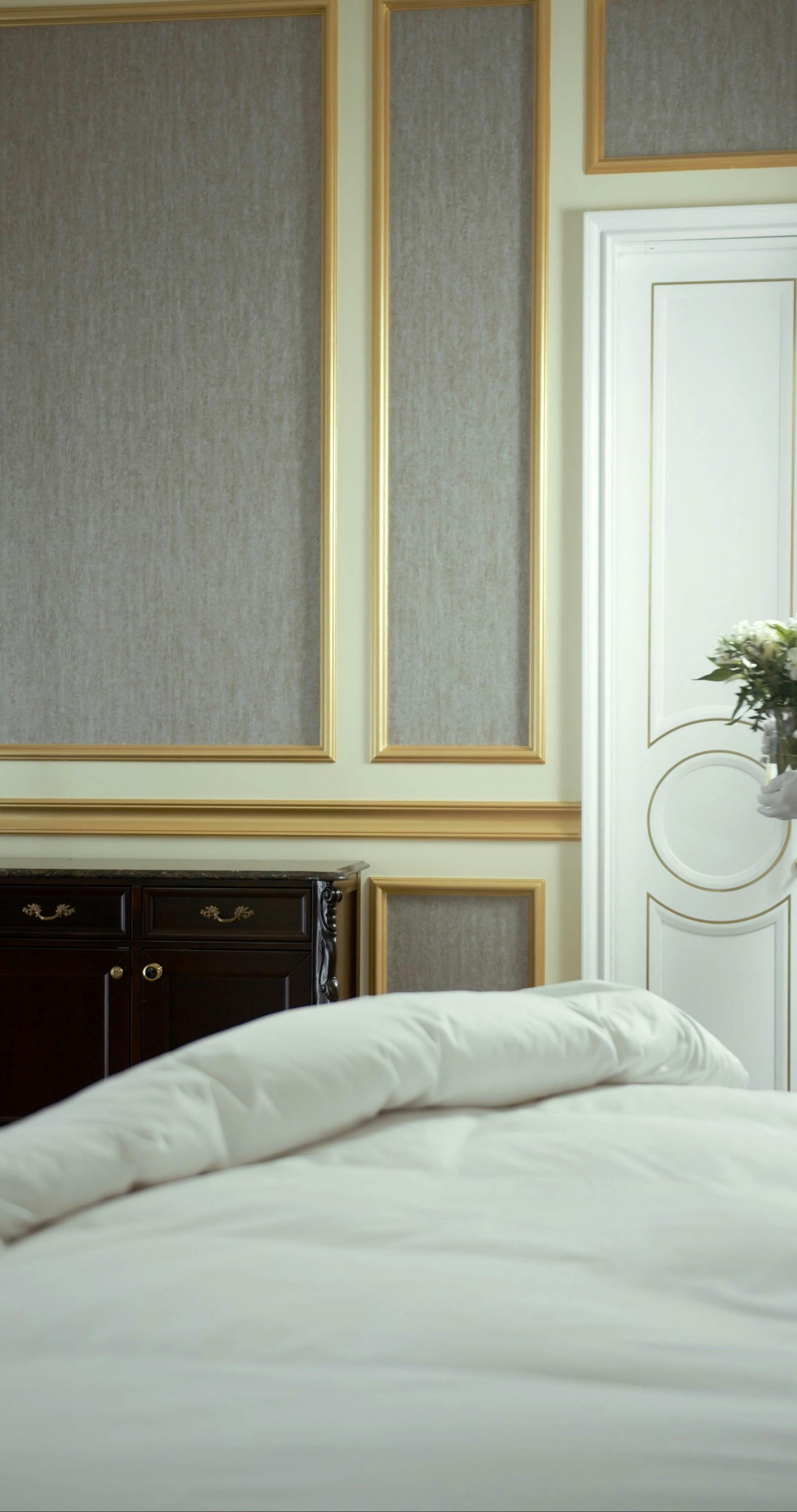 Hotel Maid Placing Flower Vase on Dresser · Free Stock Video