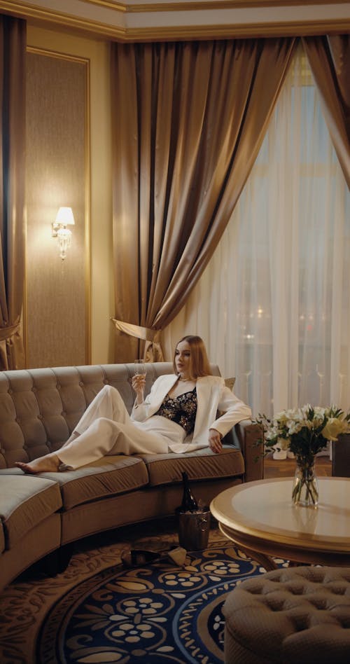 Elegant Woman Drinking Champagne In The Sofa
