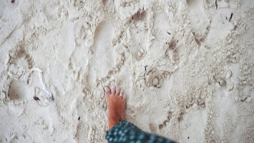 Woman Stepping In The Sand