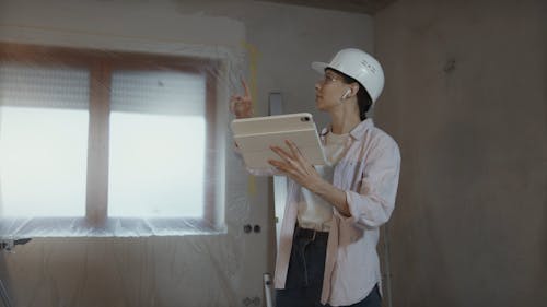 Woman Renovating Home and Using Tablet