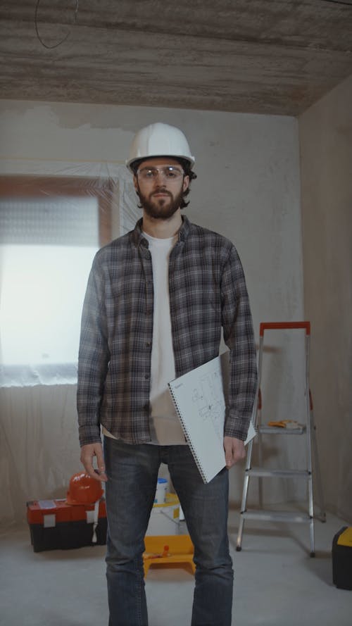 Man in Hardhat Holding Blueprint