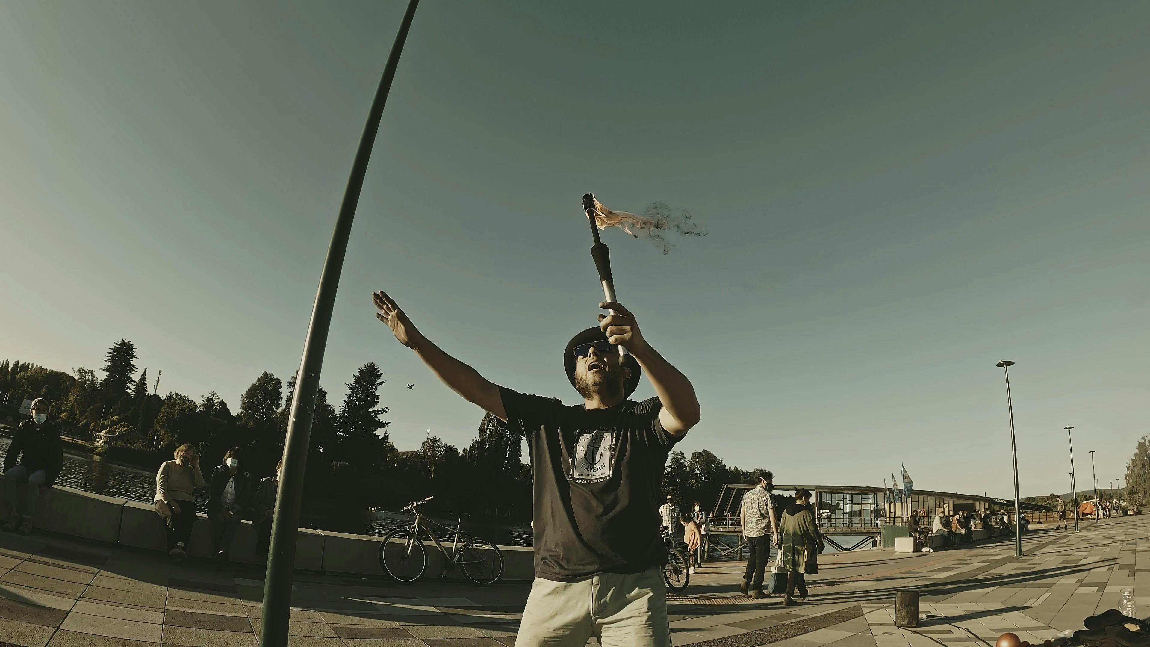 A Man Juggling Sticks With Fire on the Street Free Stock Video Footage