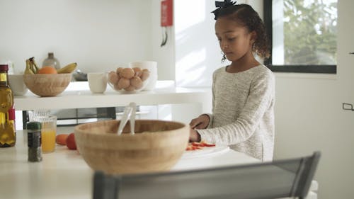 Girl Slicing a Bell Pepper