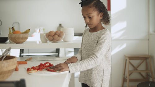 A Girl Cutting  Bell Pepper