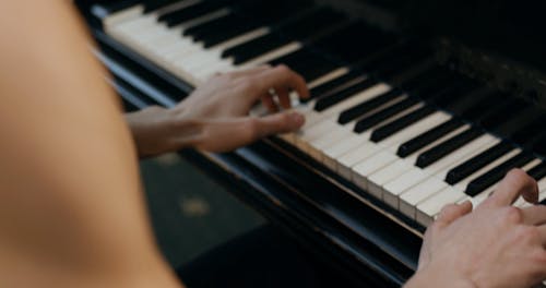 Man with Tattoos Playing Piano