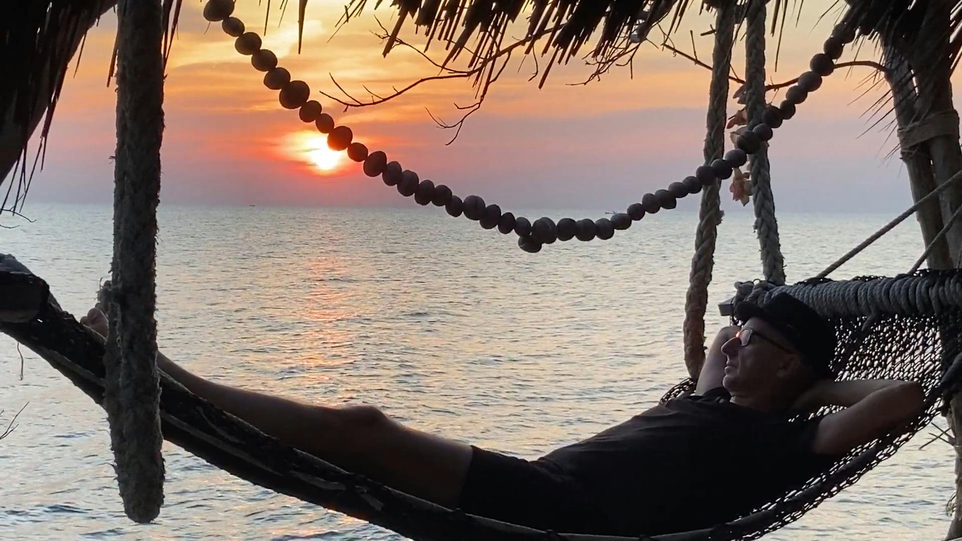 Man Chilling in a Hammock by the Beach During Sunset · Free Stock Video