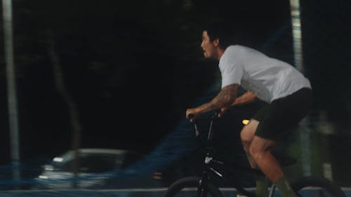 Young Man Performing Tricks with Bicycle