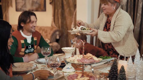 A Lady Serving Christmas Dinner for her Family