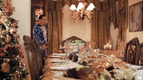 A Family Sitting at a Christmas Table 