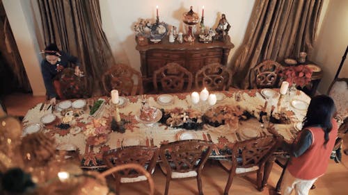 Two Women Setting up a Christmas Dinner Table